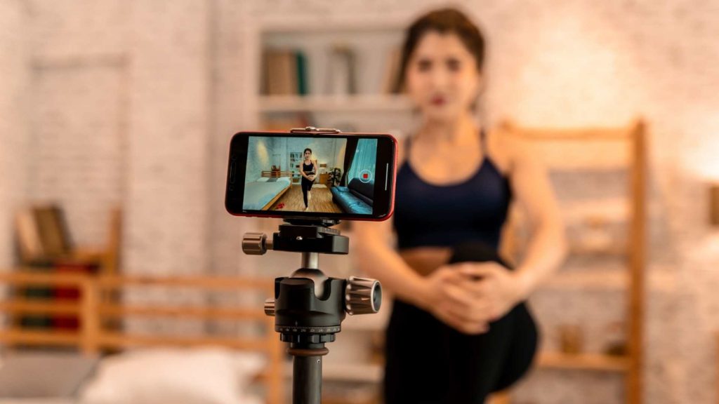 Personal trainer recording online workout